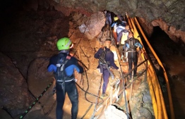 This undated handout photo taken recently and released by the Royal Thai Navy on July 7, 2018 shows a group of Thai Navy divers in Tham Luang cave during rescue operations for the 12 boys and their football team coach trapped in the cave at Khun Nam Nang Non Forest Park in the Mae Sai district of Chiang Rai province. / AFP PHOTO / ROYAL THAI NAVY / Handout / 