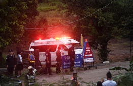An ambulance leaves the Tham Luang cave area after divers evacuated some of the 12 boys and their coach trapped at the cave in Khun Nam Nang Non Forest Park in the Mae Sai district of Chiang Rai province on July 8, 2018.
Elite divers on July 8 began the extremely dangerous operation to extract 12 boys and their football coach who have been trapped in a flooded cave complex in northern Thailand for more than two weeks, as looming monsoon rains threatened the rescue effort. / AFP PHOTO / LILLIAN SUWANRUMPHA /  