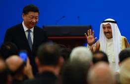 Kuwaiti ruling Emir Sheikh Sabah al-Ahmad al-Jaber al-Sabah (R) waves after giving a speech as China's President Xi Jinping (L) looks on, during the 8th Ministerial Meeting of China-Arab States Cooperation Forum at the Great Hall of the People in Beijing on July, 10, 2018.
China will provide Arab states with 20 billion USD in loans for economic development, President Xi Jinping told top Arab officials on July 10, as Beijing seeks to build its influence in the Middle East and Africa. / AFP PHOTO / WANG ZHAO