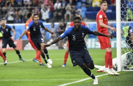 France's defender Samuel Umtiti celebrates scoring the opening goal during the Russia 2018 World Cup semi-final football match between France and Belgium at the Saint Petersburg Stadium in Saint Petersburg on July 10, 2018. / AFP PHOTO / CHRISTOPHE SIMON / 