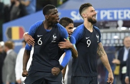 (L to R) France's midfielder Paul Pogba, France's defender Raphael Varane and France's forward Olivier Giroud celebrate at the end of the Russia 2018 World Cup semi-final football match between France and Belgium at the Saint Petersburg Stadium in Saint Petersburg on July 10, 2018. / AFP PHOTO / CHRISTOPHE SIMON / 