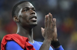 France's midfielder Paul Pogba celebrates the team's victory in the Russia 2018 World Cup semi-final football match between France and Belgium at the Saint Petersburg Stadium in Saint Petersburg on July 10, 2018. / AFP PHOTO / Paul ELLIS / 