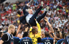 France's coach Didier Deschamps is tossed by players at the end of the Russia 2018 World Cup final football match between France and Croatia at the Luzhniki Stadium in Moscow on July 15, 2018. / AFP PHOTO / FRANCK FIFE / 