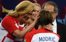 Croatian President Kolinda Grabar-Kitarovic (L) embraces Croatia's midfielder Luka Modric on the stage at the end of the Russia 2018 World Cup final football match between France and Croatia at the Luzhniki Stadium in Moscow on July 15, 2018.
France won the World Cup for the second time in their history after beating Croatia 4-2 in the final in Moscow's Luzhniki Stadium on Sunday. / AFP PHOTO / Jewel SAMAD / 