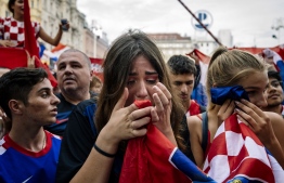 Croatian supporters react during the 2018 Russia World Cup final football match between Croatia and France, the first final World Cup match ever in the history of Croatia. / AFP PHOTO / DIMITAR DILKOFF