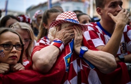 Croatian supporters react after the 2018 Russia World Cup final football match between Croatia and France, on July 15, 2018 in Zagreb the first final World Cup match ever in the history of Croatia. / AFP PHOTO / DIMITAR DILKOFF