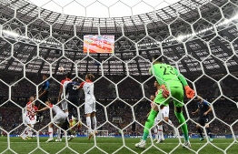 Croatia's forward Mario Mandzukic (5L) heads France's forward Antoine Griezmann's free kick into his own net scoring an own goal during their Russia 2018 World Cup final football match between France and Croatia at the Luzhniki Stadium in Moscow on July 15, 2018.  FRANCK FIFE / AFP