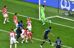 The ball goes in off of Croatia's forward Mario Mandzukic's head for the opening goal during the Russia 2018 World Cup final football match between France and Croatia at the Luzhniki Stadium in Moscow on July 15, 2018.  Mladen ANTONOV / AFP