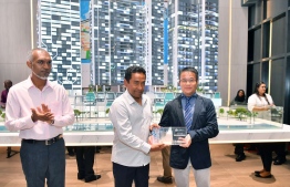 President Abdulla Yameen is presented with a miniature model of the 'Coral Boulevard' mixed use residential towers being developed at Rasfannu. PHOTO/PRESIDENT'S OFFICE