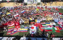 Futsal teams hold up their national flags for a group photo at the World Finals of Neymar Jr’s Five held last weekend at Praia Grande, Brazil. PHOTO: MARCELO MARAANI/RED BULL CONTENT POOL