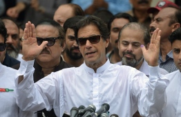 Pakistan's cricketer-turned politician Imran Khan of the Pakistan Tehreek-e-Insaf (Movement for Justice) speaks to the media after casting his vote at a polling station during the general election in Islamabad on July 25, 2018.
Pakistanis voted July 25 in elections that could propel former World Cup cricketer Imran Khan to power, as security fears intensified with a voting-day blast that killed at least 30 after a campaign marred by claims of military interference. / AFP PHOTO / AAMIR QURESHI