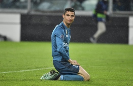 (FILES) In this file photo taken on April 03, 2018 Real Madrid's Portuguese forward Cristiano Ronaldo reacts after missing a goal during the UEFA Champions League quarter-final first leg football match between Juventus and Real Madrid at the Allianz Stadium in Turin on April 3, 2018.
After ordering football superstar Cristiano Ronaldo to pay 18.8 million euros ($21.6 million) to settle a tax fraud claim, Spanish authorities have reduced the sum by two million euros, the El Mundo daily reported on August 10, 2018. Spain's taxman and Ronaldo's advisors made the deal to settle claims the 33-year-old, who has since moved to Italy's Juventus, hid income generated from  image rights while he was playing for Real Madrid.
 / AFP PHOTO / Alberto PIZZOLI