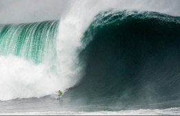 Garett McNamara surfs XXL Nazare' in 2015. PHOTO: BRUNO ALEIXO / WORLD SURF LEAGUE