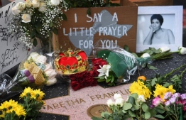 Flowers and tributes are placed on the Star for Aretha Franklin on the Hollywood Walk of Fame in Hollywood, California, August 16, 2018, after the music icon, legendary singer and "Queen of Soul" loved by millions whose history-making career spanned six decades, died, her longtime publicist announced. 
Franklin, who was 76, influenced generations of female singers with unforgettable hits including "Respect" (1967), "Natural Woman" (1968) and "I Say a Little Prayer" (1968). She passed away at home August 16, 2018 in Detroit from advanced pancreatic cancer. / AFP PHOTO / Mark RALSTON
