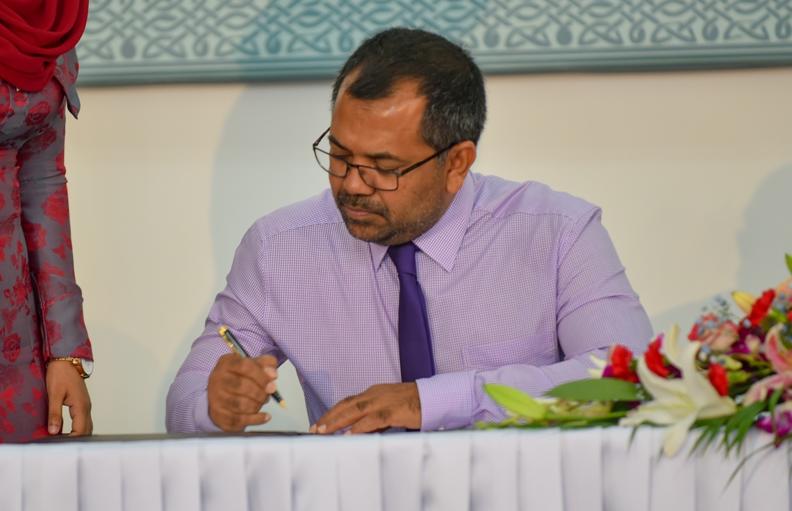 މާލެ: އޮގަސްޓް 18، 2018- މި އަހަރުގެ ރިޔާސީ އިންތިޚާބުގައި ވާދަކުރައްވާ ދެ ކެންޑިޑޭޓުންގެ ނަން ތަރުތީބު ކުރުމަށްޓަކައި އިލެކްޝަންސް ކޮމިޝަންގައި ބޭއްވި ހަފުލާގައި، ޕީޕީއެމްގެ ކެންޑިޑޭޓް ރައީސް ޔާމީންގެ ފަރާތްޕުޅުން ބައިވެރިވެވަޑައިގެންނެވި ޒަމީރު، ކަމާއި ގުޅޭ ލިޔުމެއްގައި ސޮއިކުރައްވަނީ.---ފޮޓޯ: އަހުމަދު ނިޝާތު/މިހާރު