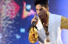 (FILES): This June 30, 2011 file photo shows US singer and musician Prince performing on stage at the Stade de France in Saint-Denis, outside Paris. 
The estate of prolific late pop icon Prince made more than 300 songs from his later career available on digital download and streaming services for the first time on Friday, August 17, 2018. The tracks come from 23 albums -- from 1995's "The Gold Experience" to 2010's "20Ten" -- that have been launched online as part of a deal struck with Sony's Legacy Recordings. There is also a new 37-track compilation called "Prince Anthology 1995-2010," made up of highlights from the 23 albums.

 / AFP PHOTO / BERTRAND GUAY