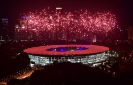 Fireworks explode over the Gelora Bung Karno main stadium during the opening ceremony of the 2018 Asian Games in Jakarta on August 18, 2018. / AFP PHOTO / MONEY SHARMA