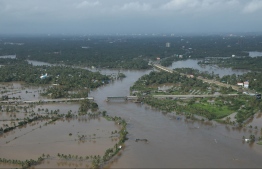 View of a flooded area is pictured in the north part of Kochi, in the Indian state of Kerala on August 18, 2018.
Rescuers in helicopters and boats fought through renewed torrential rain on August 18 to reach stranded villages in India's Kerala state as the toll from the worst monsoon floods in a century rose above 320 dead. / AFP PHOTO / -
