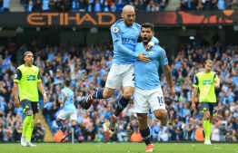 FILE PHOTO: Manchester City's Argentinian striker Sergio Aguero (R) celebrates scoring the opening goal with Manchester City's Spanish midfielder David Silva (L) during the English Premier League football match between Manchester City and Huddersfield Town at the Etihad Stadium in Manchester, north west England, on August 19, 2018. / AFP PHOTO / Lindsey PARNABY /