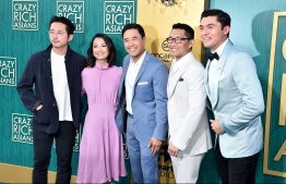 (FILES) In this file photo taken on August 7, 2018 Steven Yeun, Jae Suh Park, Randall Park, Daniel Dae Kim and Henry Golding attend the premiere of Warner Bros. Pictures' "Crazy Rich Asiaans" at TCL Chinese Theatre IMAX in Hollywood, California.  
Highly anticipated rom-com "Crazy Rich Asians" -- the first Hollywood film with an mainly Asian cast in a generation -- dazzled the North American box office in its debut weekend, claiming the top spot, industry estimates showed August 19, 2018.The Warner Bros. adaptation of Kevin Kwan's best-selling novel of the same name raked in $34 million since hitting theaters on Wednesday, box office tracker Exhibitor Relations said. Of the total, the film took in $25.2 million at the weekend.
 / AFP PHOTO / GETTY IMAGES NORTH AMERICA / Alberto E. Rodriguez