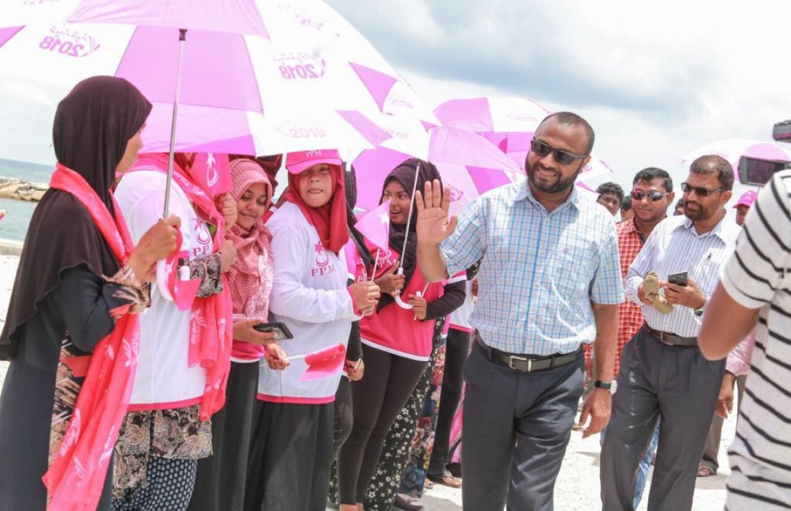 ލ. އަތޮޅު: އޮގަސްޓް 26، 2018- ޕީޕީއެމްގެ ރިޔާސީ ކެންޑިޑޭޓް ރައީސް ޔާމީންގެ ރަނިންމޭޓް ޑރ. ޝަހީމް މި އަތޮޅުގެ ރަށަކަށް ވަޑައިގަތުމުން މަރުހަބާ ދަންނަވަން އެއްވި އަންހެނުންތަކަކަށް އަތުގެ އިޝާރާތުން ސަލާމް ކުރައްވަނީ.---ފޮޓޯ: ޕީޕީއެމް