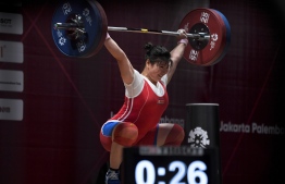 North Korea's Rim Jong Sim lifts during the snatch women's 75kg weightlifting group A event during 2018 Asian Games in Jakarta on August 26, 2018. / AFP PHOTO / CHAIDEER MAHYUDDIN