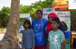 September 1, 2018, L. Maabaidhoo: Chief Guest Zoona Naseem (L-2) pose with festival-goers at the Laamu Turtle Festival 2018. PHOTO: HAWWA AMAANY ABDULLA / THE EDITION