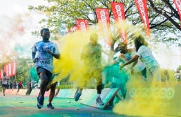 Participants are rewarded with a burst of colour powder at a kilometre-mark during the Ooredoo Color Run 2017 in Hulhumale. PHOTO/OOREDOO