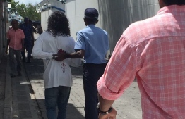 Police arrest a man accused of gang violence. FILE PHOTO/MIHAARU