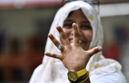 A voter showing off her finger mark after voting in the Presidential Elections 2018. PHOTO: NISHAN ALI / MIHAARU