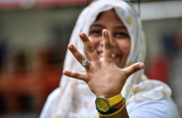 September 23, 2018: A woman shows off the voting ink on her finger in the Presidential Elections 2018. PHOTO: NISHAN ALI/MIHAARU