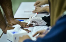 September 23, 2018: An election official draws the electoral stain on a voter's finger during the Presidential Elections 2018. PHOTO: NISHAN ALI/MIHAARU