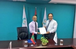 CSC's president handing over the official documents to Ahmed Latheef. PHOTO: MDP