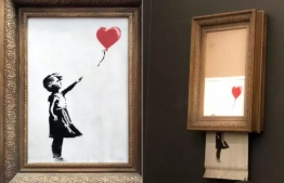 The Banksy artwork shredded itself during the auction. Photo: PA