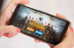 Person playing PUBG on a mobile phone --