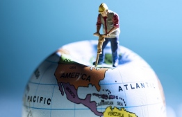 (FILES) This file photograph taken on August 20, 2018, shows an illustration of a figurine of a worker with a jackhammer on a globe in Paris. 
Avoiding global climate chaos will require a major transformation of society and the world economy that is "unprecedented in scale," the UN said October 8, 2018, in a landmark report that warns time is running out to avert disaster. / AFP PHOTO / JOEL SAGET