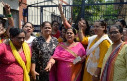 Indian activists shout slogans outside a police station as they demand justice for Bollywood actress Tanushree Dutta, who has alleged a sexual harrasment by actor Nana Patekar, in Mumbai on October 11, 2018. - The Indian actress whose public allegations of sexual harassment by a Bollywood star is sparking a string of similar #MeToo claims has filed a formal complaint, police told AFP October 7. Former Miss Universe contestant Tanushree Dutta first alleged in 2008 that multi-award-winning Nana Patekar behaved inappropriately towards her during the making of a romantic comedy the same year. (Photo by PUNIT PARANJPE / AFP)
