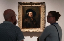 People look at Rembrandt's "Self Portrait (1660)" during a press previews at The Metropolitan Museum of Art October 15, 2018 in New York, for "In Praise of Painting: Dutch Masterpieces at The Met" and "Celebrating Tintoretto: Portrait Paintings and Studio Drawings". (Photo by TIMOTHY A. CLARY / AFP) / 