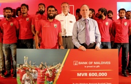BML's managing director and CEO, Andrew Healy handing over the gift card to the national football team. PHOTO: BML
