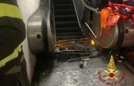 This handout picture taken and released by the Vigili del Fuoco, the Italian fire and rescue service, on October 23, 2018 shows the wreckage of an escalator after it jammed at the underground metro station "Repubblica" in Rome, injuring at least fifteen people. - Some fifteen people were injured, five seriously, including Russian supporters of CSKA Moscow on their way to attend the Champions League football match AS Rome vs CSKA Moscow, after a portion of an escalator got jammed at rush hour in the central metro station "Repubblica" of the Italian capital. (Photo by Handout / Vigili del Fuoco / AFP) / RESTRICTED TO EDITORIAL USE - MANDATORY CREDIT "AFP PHOTO / HO / VIGILI DEL FUOCO" - NO MARKETING NO ADVERTISING CAMPAIGNS - DISTRIBUTED AS A SERVICE TO CLIENTS
