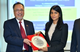 Vicente Vivencio T. Bandillo, the non-resident Phillipine Ambassador to Maldives (L), presents a plaque to Aminath Zenysha Shaheed Zaki, the Minister of Gender and Family at the Gender Awareness and Development Program (GAD) hosted by the Philippine Embassy in Bangladesh. PHOTO: HUSSAIN WAHEED/MIHAARU