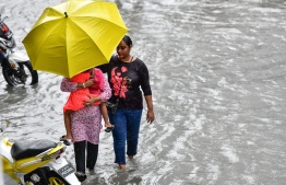 Male City: People wade through flooded streets after heavy monsoon showers. PHOTO: NISHAN ALI/MIHAARU
