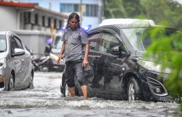 Male City: People wade through flooded streets after heavy monsoon showers. PHOTO: NISHAN ALI/MIHAARU
