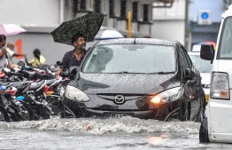 Male City: Cars drive along flooded streets after heavy monsoon showers. PHOTO: NISHAN ALI/MIHAARU