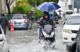 Male City: Motorcyclists drive along flooded streets after heavy monsoon showers. PHOTO: NISHAN ALI/MIHAARU