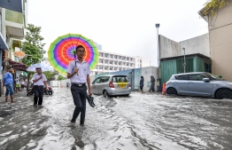 Male City: People wade through flooded streets after heavy monsoon showers. PHOTO/MIHAARU