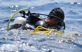 FILE PHOTO: An Indonesian Navy diver prepares to dive at an assigned point to search for the ill-fated Lion Air flight JT 610 at sea, north of Karawang on November 1, 2018. - One black box from the crashed Lion Air jet has been recovered, the head of Indonesia's National Transportation Safety Committee said on November 1, which could be critical to establishing why the brand new plane fell out of the sky. (Photo by ADEK BERRY / AFP)