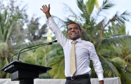 Former President Mohamed Nasheed gestures as he steps up to the podium to address the crowd gathered to welcome him at Artificial Beach. PHOTO/MIHAARU