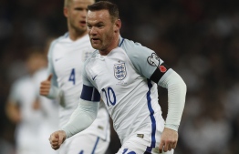 (FILES) In this file photo taken on November 11, 2016 England's striker Wayne Rooney wears a poppy armband to commemorate Armistice Day as he plays during a World Cup qualification match between England and Scotland at Wembley stadium in London. - Wayne Rooney is to come out of England retirement for a final one-off appearance against the United States in an international friendly at Wembley this month, the Football Association announced Sunday, November 4, 2018. (Photo by Adrian DENNIS / AFP) / NOT FOR MARKETING OR ADVERTISING USE / RESTRICTED TO EDITORIAL USE