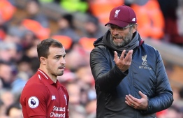 Liverpool's German manager Jurgen Klopp (R) talks with Liverpool's Swiss midfielder Xherdan Shaqiri (L) on the touchline during the English Premier League football match between Liverpool and Cardiff City at Anfield in Liverpool, north west England on October 27, 2018. (Photo by Paul ELLIS / AFP) / RESTRICTED TO EDITORIAL USE. No use with unauthorized audio, video, data, fixture lists, club/league logos or 'live' services. Online in-match use limited to 120 images. An additional 40 images may be used in extra time. No video emulation. Social media in-match use limited to 120 images. An additional 40 images may be used in extra time. No use in betting publications, games or single club/league/player publications. / 